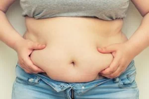 Closeup of a person with belly fat. We treat obesity naturally at lifeworks