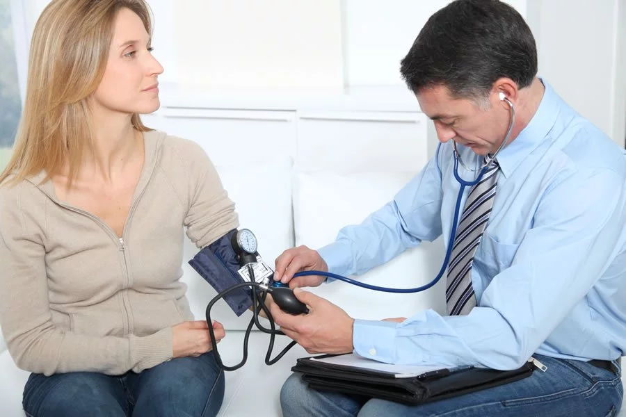 Image of a doctor taking his patient's blood pressure