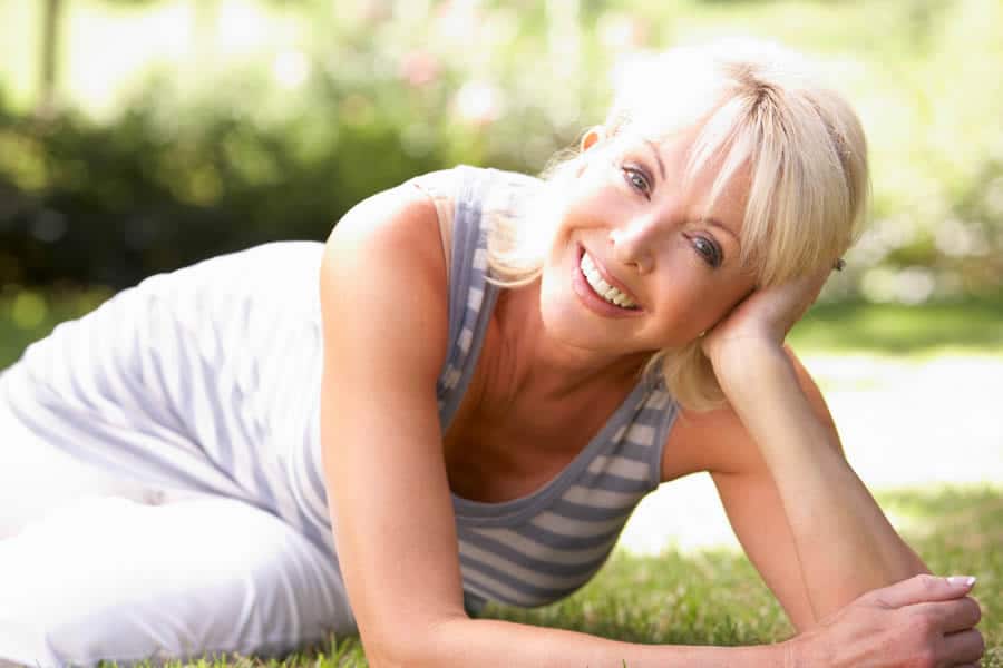 A happy woman who got rid of menopause symptoms thanks to our alternative therapies