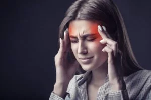 A woman suffering from severe migraines and headaches