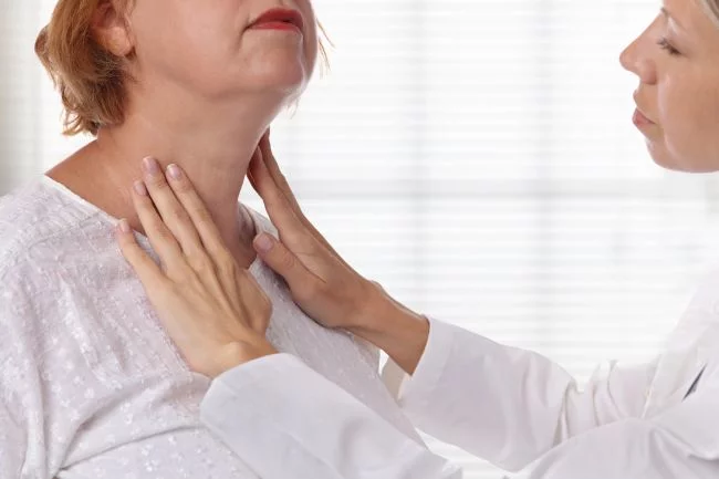 Woman with swollen neck, suffering from thyroid problems