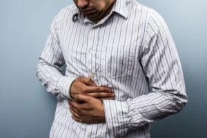 Multi racial man with constipation caused by gerd