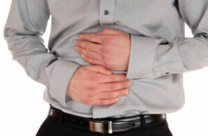 Man with stomach pain, caused by GERD