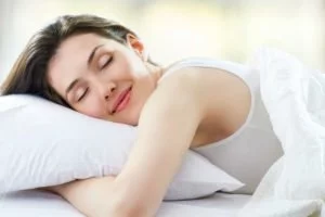 Tired woman with adrenal fatigue in bed