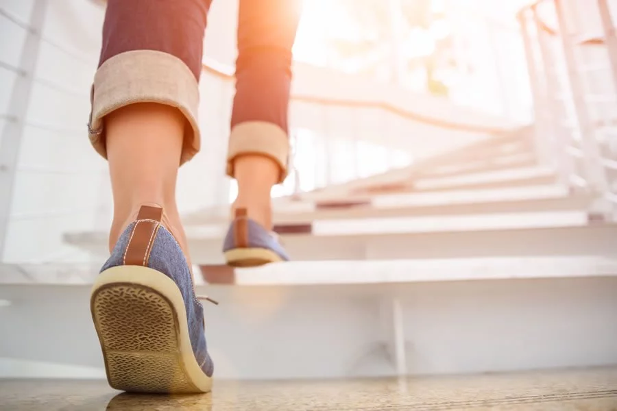A person climbing stairs. We offer Prolozone therapy for many health issues
