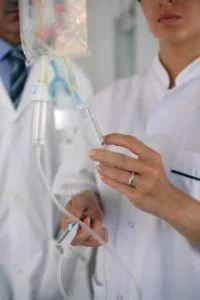Doctors preparing to administer nutritional iv therapy to a patient