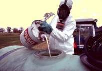 Hazardous pesticide handled by a masked worker