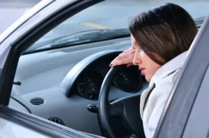 Chronically fatigued woman sleeping on the car's wheel because of lyme disease