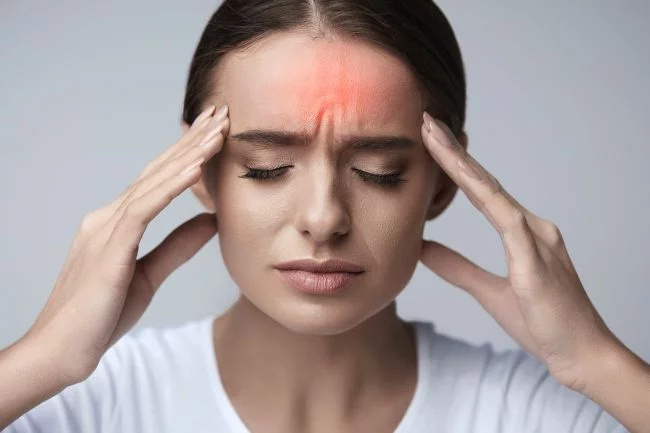 Young woman suffering from migraine