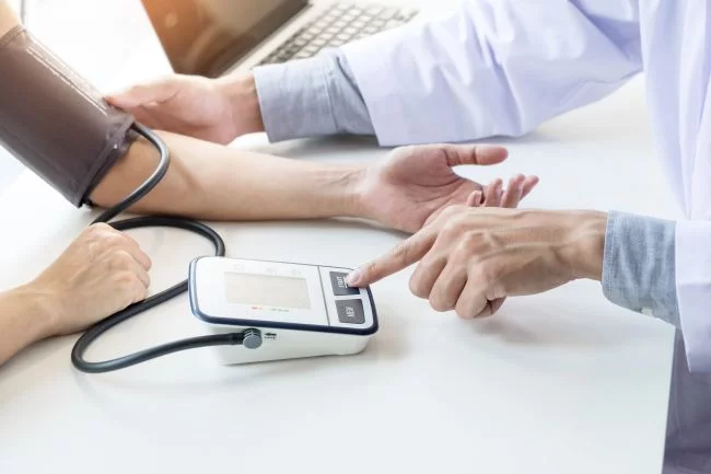 Doctor taking the patient's Blood Pressure to diagnose heart diseases