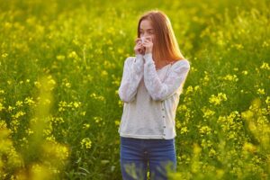 Woman in a field, suffering from Seasonal Allergies (Hay Fever)