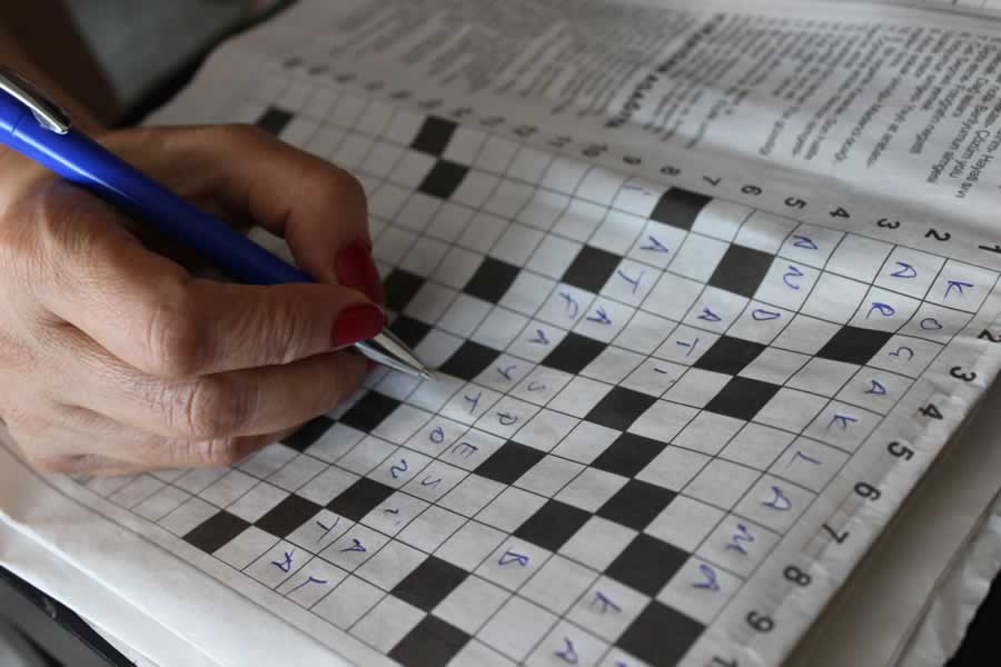 A person solving a crossword puzzle.We offer Brain Fog alternative treatments