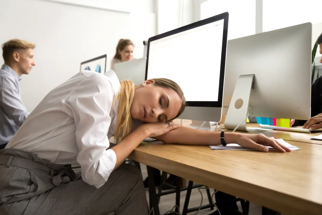 Fatigue that is not usual. Tired woman at desk.