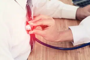 Doctor checking a heart pain with a stethoscope