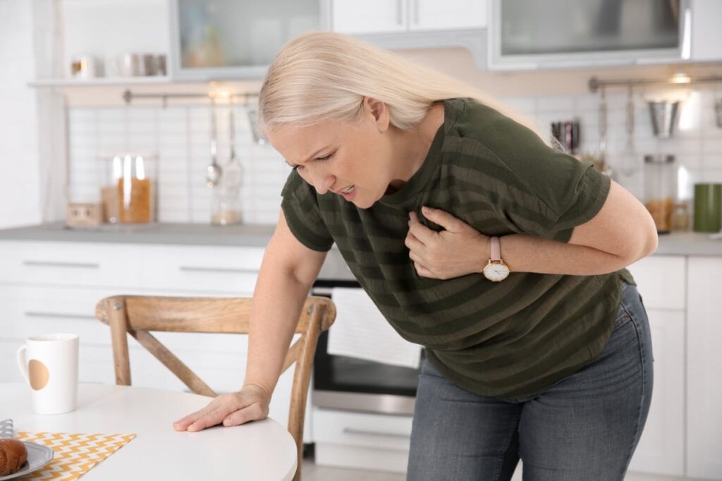 woman clutching chest, sign of a stroke