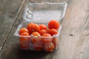 Healthy tomatoes in an unhealthy plastic container
