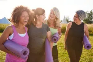 Group of happy, healthy women going to yoga class